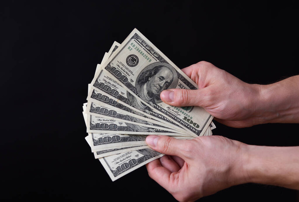 Hombre sosteniendo alrededor de 1000 dólares americanos, billetes de 100 dólares.  - Foto, Imagen