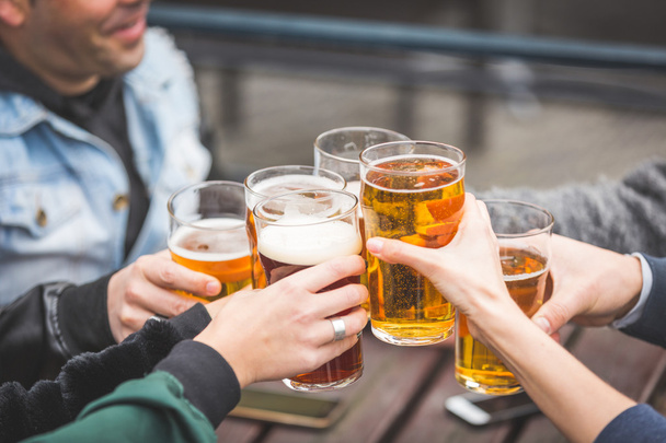 Group of friends enjoying a beer at pub in London - 写真・画像