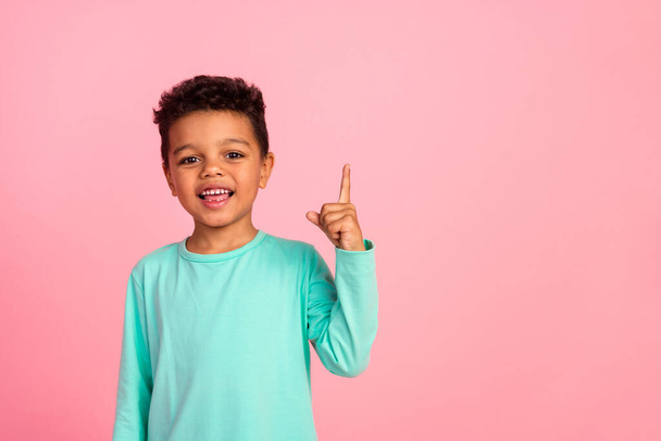 Photo portrait of cute little boy point up empty space dressed stylish cyan clothes isolated on pink color background. - Photo, image