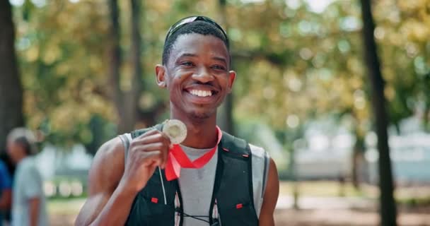 Black man, athlete and happy face with medal for winning or success, marathon and long distance running. Sportsman, achievement and victory for track outdoors, pride and fitness for sprinting race. - Footage, Video