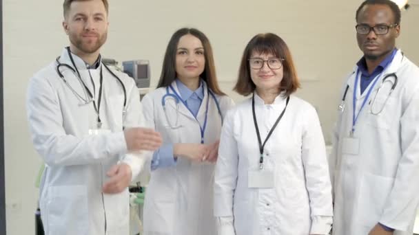 Group of doctors standing together in clinical office after working day - Footage, Video