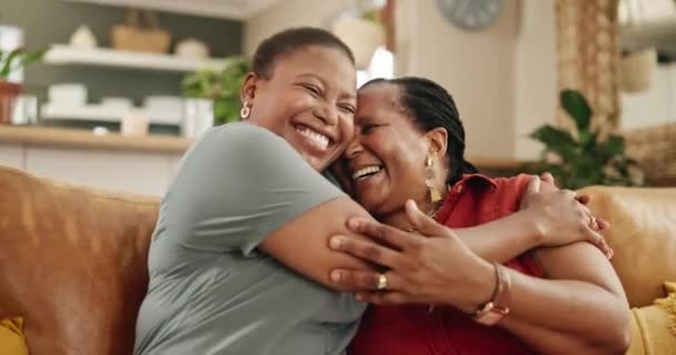 Sofa, hug and face of senior mother with woman for loving relationship, bonding and relax together. Family, home and portrait of African mom with daughter for love, care and embrace in living room. - Footage, Video