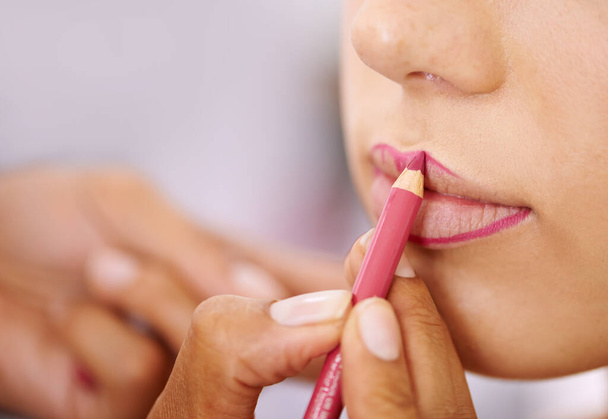 Lips, makeup pencil and woman getting ready closeup in bathroom of home for mouth cosmetics. Aesthetic, product or cosmetology and person closeup in apartment to apply lipstick with lip liner. - Photo, Image