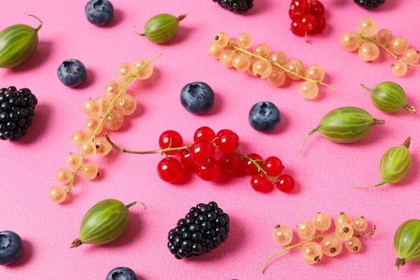Ripe berries on the table on a pink background. - Photo, Image