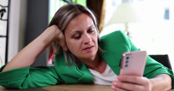 Thoughtful businesswoman woman holding smartphone contemplating problem solving. Manager received bad news sitting at desk in home office - Footage, Video
