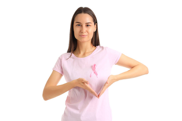 Young woman with awareness pink ribbon on white background. Breast cancer concept - Photo, Image