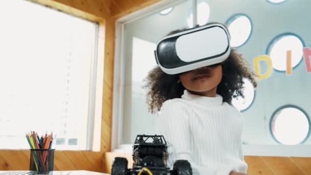 African girl wearing VR vision glasses while raised hand in the air. Student study visual reality and holding hands in front. Child using technology gadget in online education in STEM class.Erudition. - Footage, Video