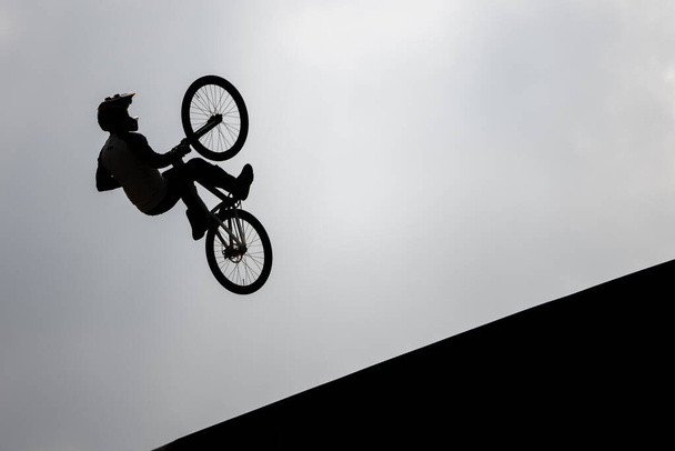 KATOWICE, POLAND - 21 AUGUST 2021: Bicycle Slopestyle World Cup. Red Bull Roof Ride Slopestyle competition in in International Conference Center in Katowice. Slopestyle big jumps, tricks in city.  - Photo, Image