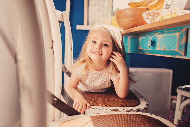 cute girl playing on kitchen. - Valokuva, kuva
