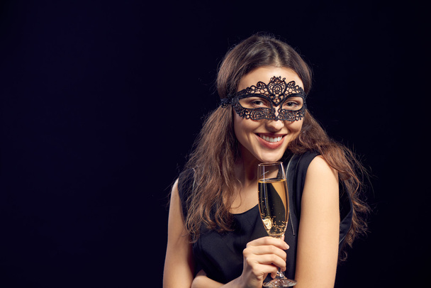 Happe woman in mask holding glass with champagne - Foto, Imagem