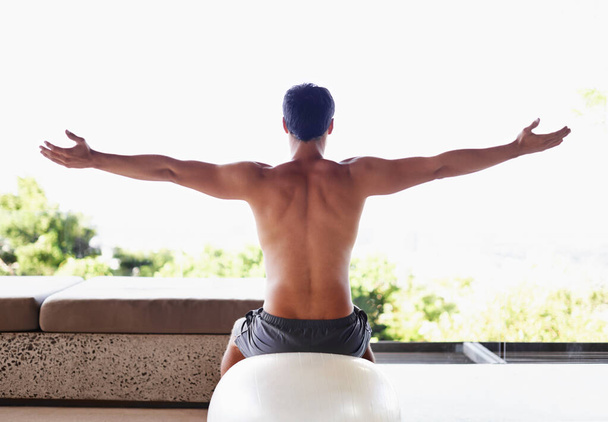Muscle, fitness and man during stretch, exercise ball and working out at gym center. Balance, athlete and core strength for health or well being, pilates and fit male sportsman at outdoor studio. - Photo, Image
