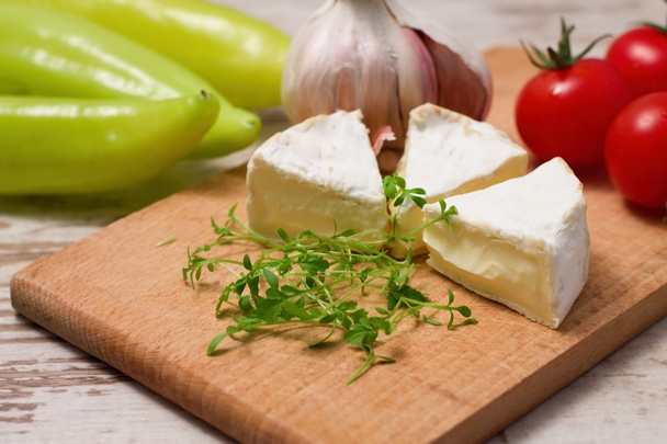 Three portions of camembert and cress on wooden board - Photo, Image