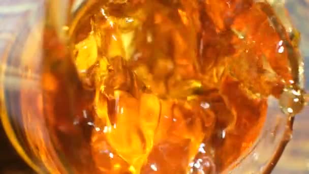 Due pezzi di ghiaccio cadono in un bicchiere di cognac al rallentatore vista dall'alto - Filmati, video
