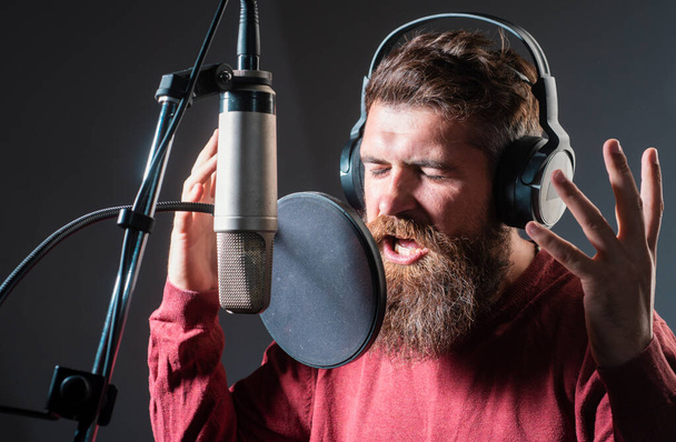 Singer singing rock recording song in a music studio. Excited Karaoke - Photo, image