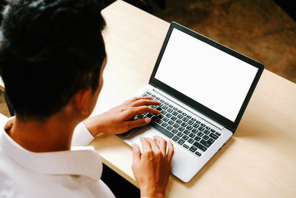 Üzleti személy vagy irodai dolgozó laptopot használ, miközben az asztalnál ül. uds - Fotó, kép