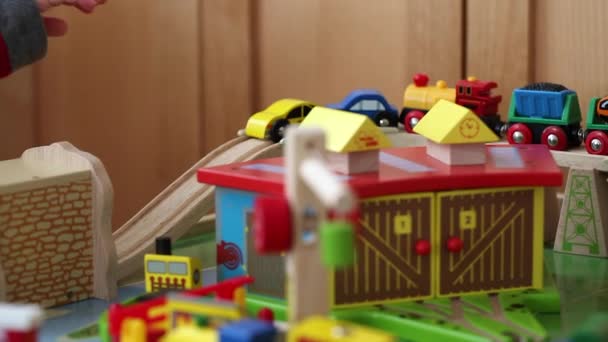 boy plays with a toy train and cars - Filmati, video