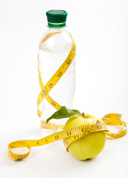 Apple core, bottled water for healthy life over a white backgrou - Valokuva, kuva
