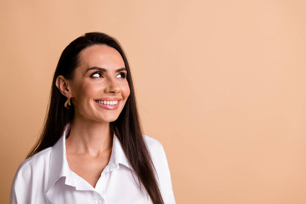 Photo of positive nice corporate lady beaming smile look empty space brainstorming isolated on beige color background. - Фото, зображення