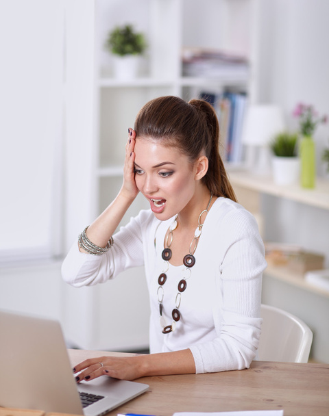 Stressed businesswoman sitting at desk - Foto, Imagen