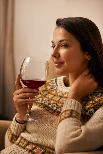 Woman, thinking and relax in home with wine for daydreaming, wellness and weekend break with happiness. Person, face and thoughtful in living room with alcohol for antioxidant or celebration in house. - Photo, Image