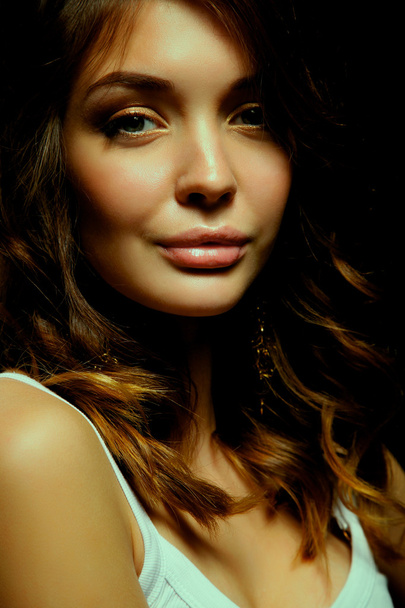 Portrait of beautiful young woman face. Isolated on dark background - Foto, immagini