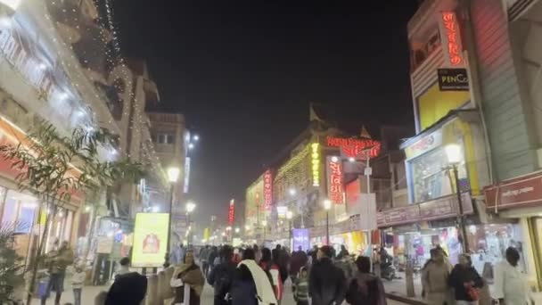 Varanasi, Uttar Pradesh, India - January 20 2024: View of godowlia chowk of varanasi city in night with crowd roaming. This place is famous of baba kashi vishwanath temple and bank of river gnages. - Footage, Video
