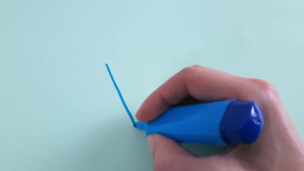 SIM em polaco, ucraniano. A mão da mulher escreve a palavra Tak com marcador azul sobre fundo de papel azul claro.  - Filmagem, Vídeo