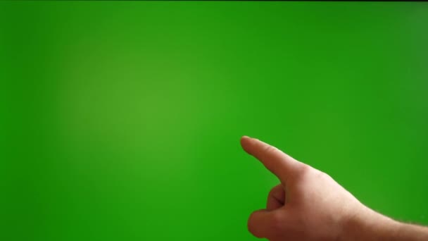 Человеческая рука показывает жест с указательным пальцем на зеленом фоне. - Кадры, видео