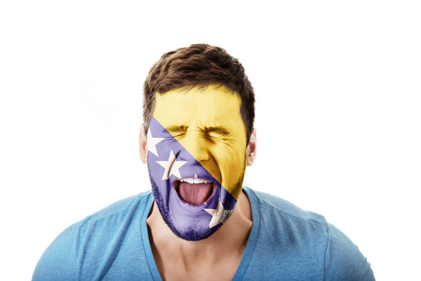 Man with Bosnia and Herzegovina flag on face. - Foto, Imagem