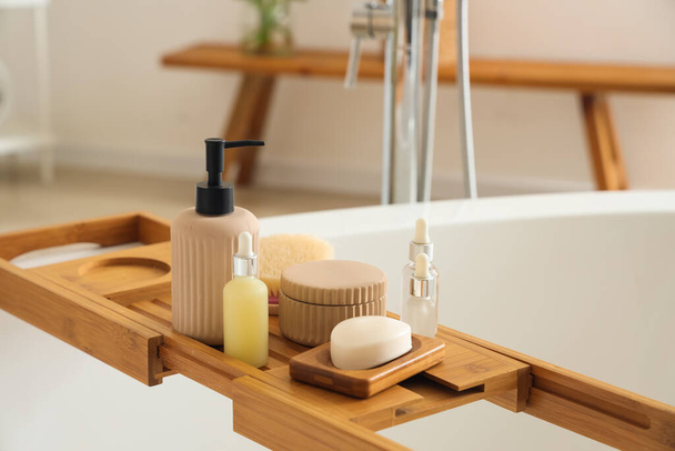 Drewniana taca na wannę z kosmetykami w łazience - Zdjęcie, obraz