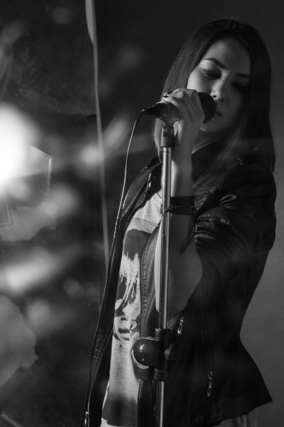 girl singing into a microphone in a studio - Fotó, kép