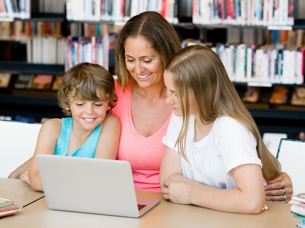 Mother with kids in library - Photo, Image