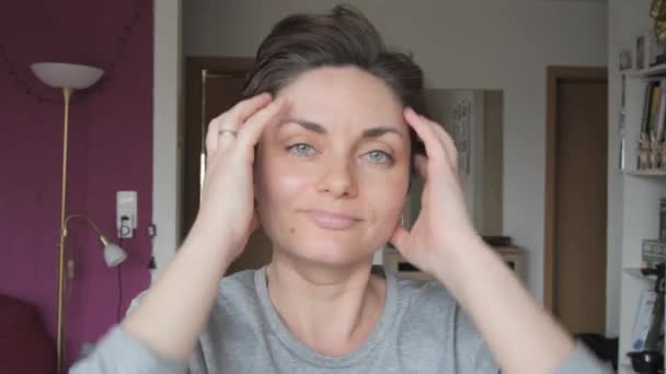 A young woman touches her short hair with her hands, showing her first gray hair. Early gray hair in women Life personal changes concept - Footage, Video