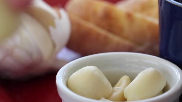 Woman rubs garlic on baguettes - Кадри, відео
