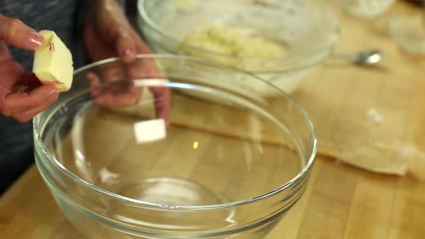Woman buttering bowl - Filmati, video