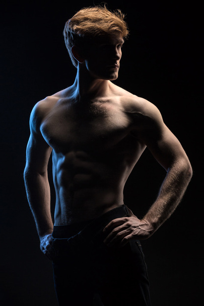 Portrait of handsome red-haired athlete topless at the studio - Foto, Bild