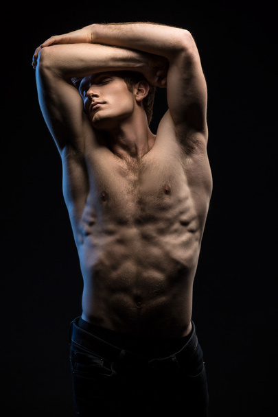 Portrait of handsome red-haired athlete topless at the studio - Foto, Imagem