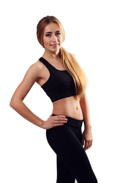 fitness woman in sport style standing against white background.  - 写真・画像