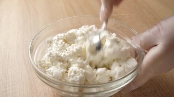 Sour cream is added to sour milk cheese and mixed. - Footage, Video