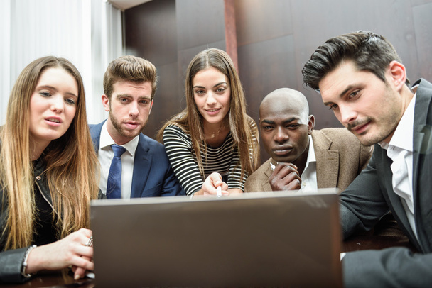 Group of multiethnic busy people looking at a laptop - Photo, Image