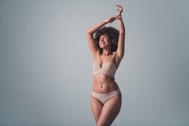 Unretouched photo of body positive girl raise hands enjoy buy new women lingerie isolated pastel color background. - 写真・画像