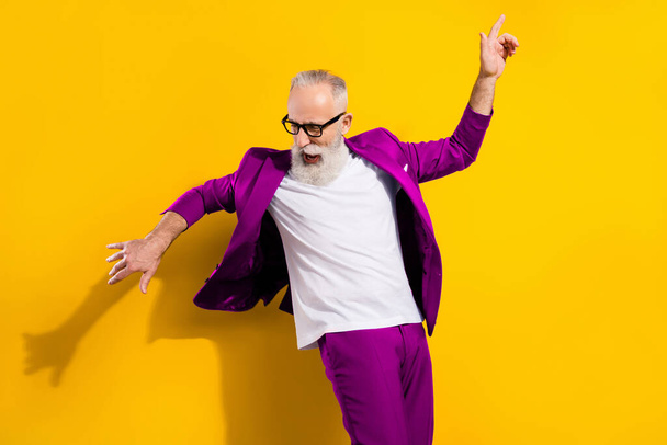 Photo portrait of senior man in blue suit dancing at party isolated bright yellow color background. - Photo, Image