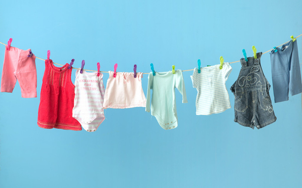 Colorful baby's clothes getting dry - Fotoğraf, Görsel