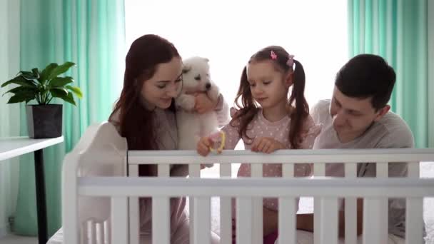 Happy family with two children and a small white puppy. Happy family concept. The concept of pets in the family. Slow motion. - Footage, Video
