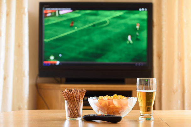 television, TV watching (football, soccer match) with snacks lyi - Foto, Imagen