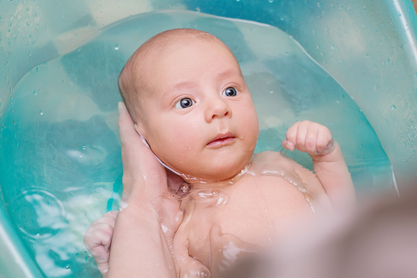 cute newborn bathes in a bathroom - Photo, Image