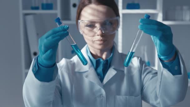 Qualified biochemist in a clinical environment where the development of pharmaceuticals is studied. The video highlights the purpose of rigorous sample analysis in a transparent environment and the - Footage, Video