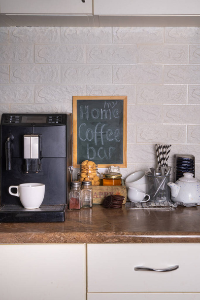 Home Coffee Station, Coffee Bar. кухонный уголок с кофеваркой, кофейными зёрнами, чаем, сладостями и начинками для напитков - Фото, изображение