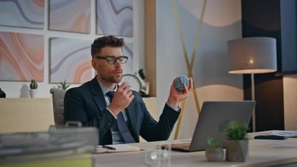 Corporate professional throwing ball in contemporary office closeup. Company leader brainstorming planning strategy alone. Pensive successful businessman resting looking distance in modern cabinet - Footage, Video