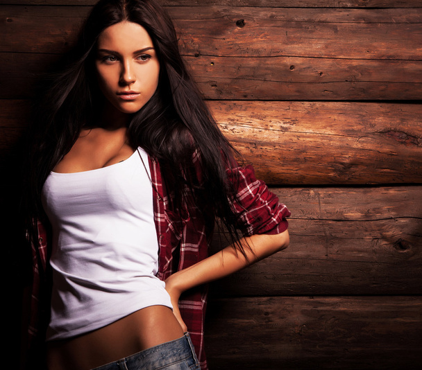 Young sensual & beauty woman in casual clothes pose on grunge wooden background. - Zdjęcie, obraz
